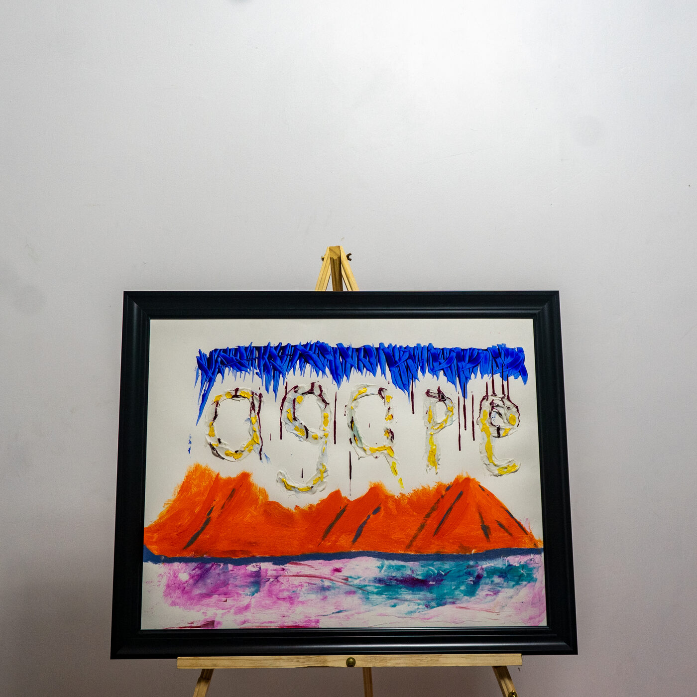 Painting reading agape over a mountain and water scene