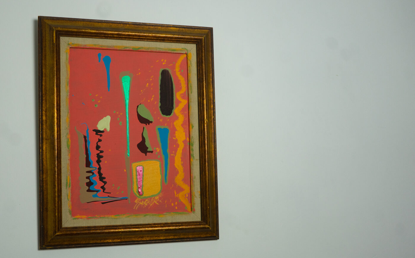 Abstract painting in coral, teal, and black with vertical drips